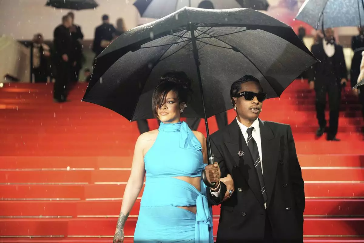 Rihanna, left, and A$AP Rocky pose for photographers upon departure from the premiere of the film 'Highest 2 Lowest' at the 78th international film festival, Cannes, southern France, Monday, May 19, 2025. (Photo by Lewis Joly/Invision/AP)