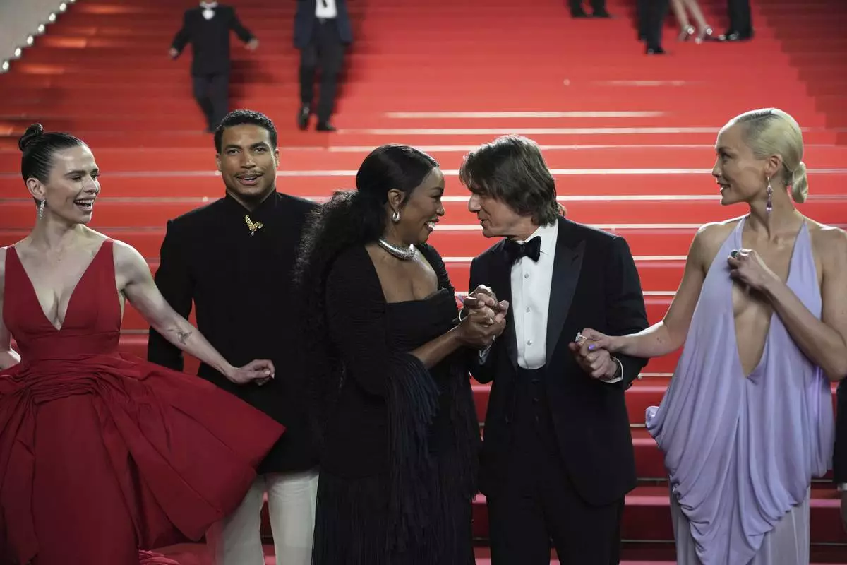 Hayley Atwell, from left, Greg Tarzan Davis, Angela Bassett, Tom Cruise, and Pom Klementieff pose for photographers upon departure from the premiere of the film 'Mission: Impossible – The Final Reckoning' at the 78th international film festival, Cannes, southern France, Wednesday, May 14, 2025. (AP Photo/Natacha Pisarenko)