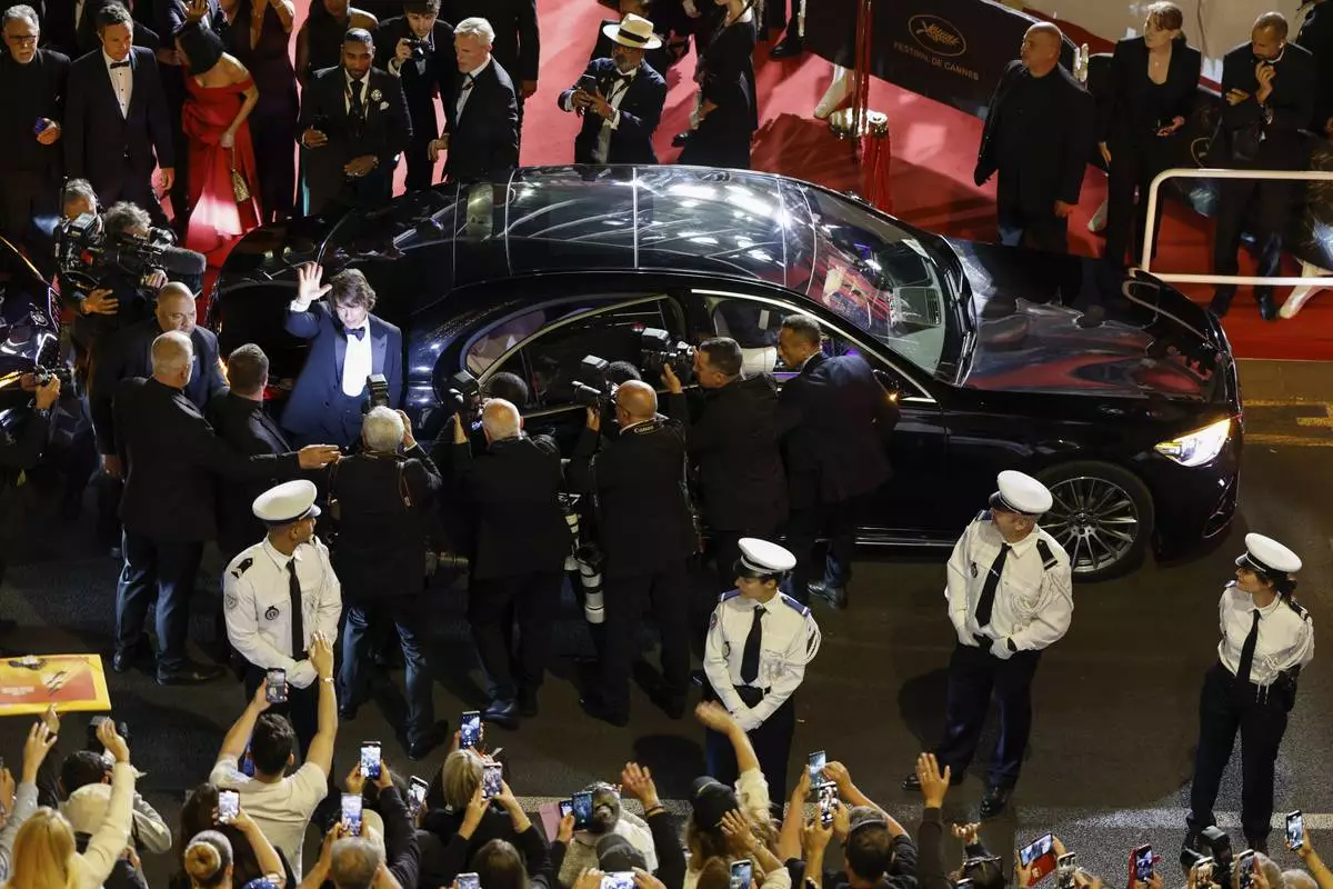 Tom Cruise waves to fans upon departure from the premiere of the film 'Mission: Impossible – The Final Reckoning' at the 78th international film festival, Cannes, southern France, Wednesday, May 14, 2025. (Photo by Millie Turner/Invision/AP)