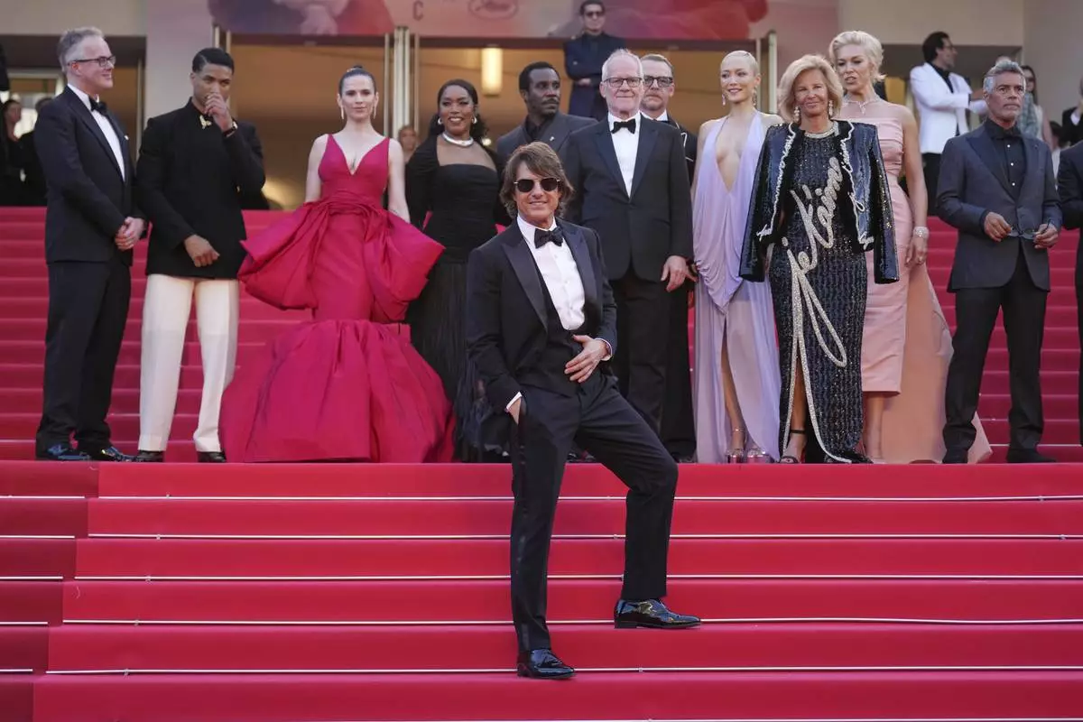 Tom Cruise, front, editor Eddie Hamilton, from back left, Greg Tarzan Davis, Hayley Atwell, Angela Bassett, Tramell Tillman, festival director Thierry Fremaux, Simon Pegg, Pom Klementieff, Iris Knobloch, Hannah Waddingham and Esai Morales pose for photographers upon arrival at the premiere of the film 'Mission: Impossible - The Final Reckoning' at the 78th international film festival, Cannes, southern France, Wednesday, May 14, 2025. (AP Photo/Natacha Pisarenko)