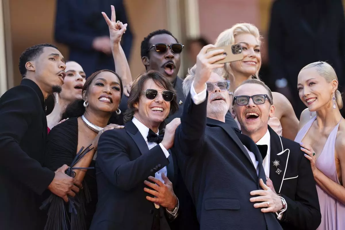 Greg Tarzan Davis, from left, Hayley Atwell, Angela Bassett, Tom Cruise, Tramell Tillman, director Christopher McQuarrie, Hannah Waddingham, Simon Pegg and Pom Klementieff pose for photographers upon arrival at the premiere of the film 'Mission: Impossible - The Final Reckoning' at the 78th international film festival, Cannes, southern France, Wednesday, May 14, 2025. (Photo by Scott A Garfitt/Invision/AP)