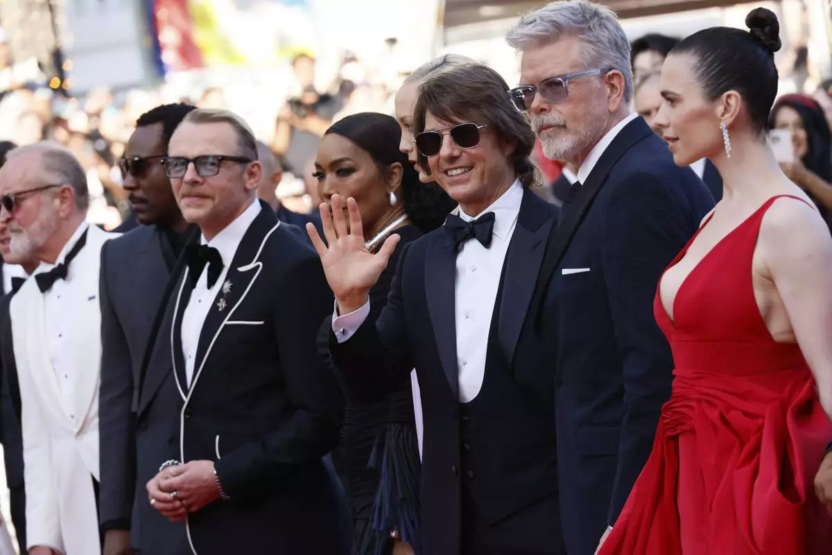 Writer Erik Jendresen, from left, Tramell Tillman, Simon Pegg, Angela Bassett, Pom Klementieff, Tom Cruise, director Christopher McQuarrie and Hayley Atwell pose for photographers upon arrival at the premiere of the film 'Mission: Impossible - The Final Reckoning' at the 78th international film festival, Cannes, southern France, Wednesday, May 14, 2025. (Photo by Joel C Ryan/Invision/AP)