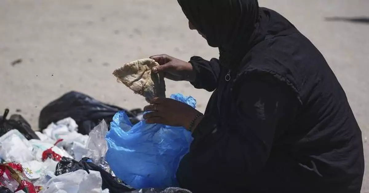 A family digs through trash for bits of food, showing Gaza's growing desperation