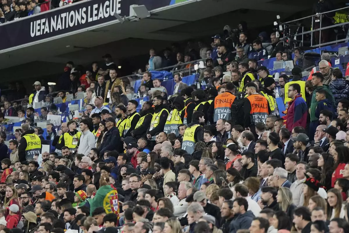 Match stewards form a line at the stands during the Nations League final soccer match between Portugal and Spain at the Allianz Arena in Munich, Germany, Sunday, June 8, 2025. (AP Photo/Martin Meissner)