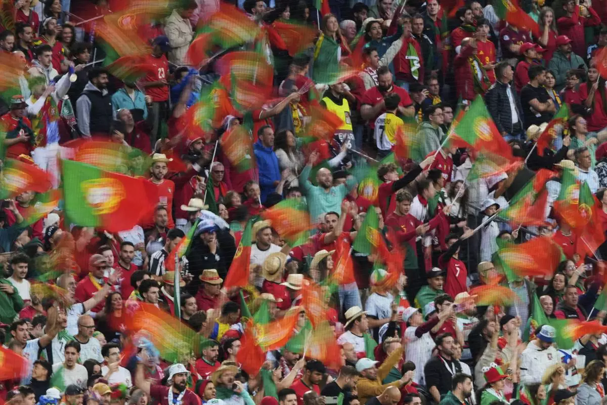 Fans of Portugal wait for the beginning of the Nations League final soccer match between Portugal and Spain at the Allianz Arena in Munich, Germany, Sunday, June 8, 2025. (AP Photo/Michael Probst)