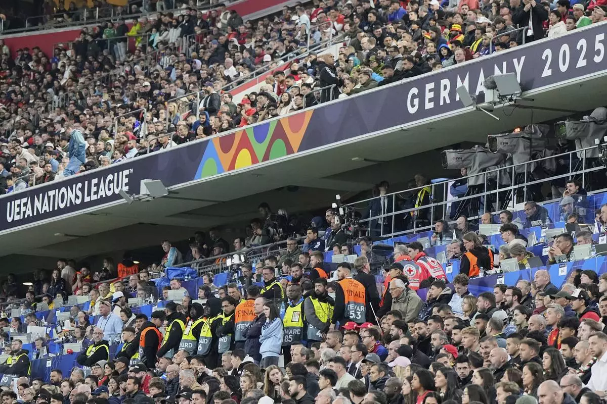 Stewards secure the media tribune after a soccer fan died after falling from an overhead level onto a media area below during the Nations League Final soccer match between Spain and Portugal in Munich, Germany, Sunday, June 8, 2025. (AP Photo/Martin Meissner)
