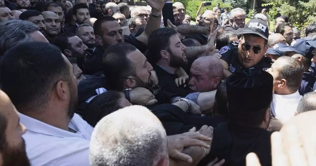 Crowds block Armenian security forces seeking to arrest a clergyman who criticized the government