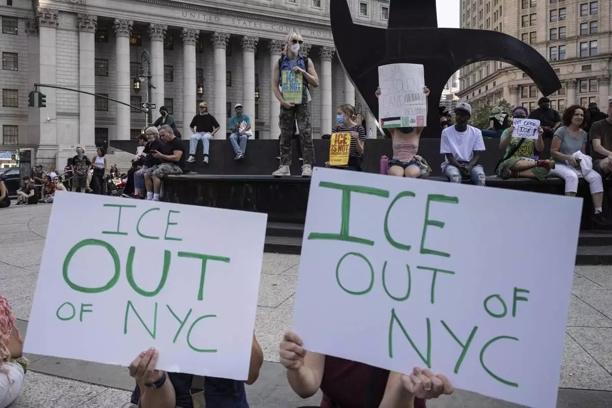 Demonstrators hold signs and chant during a protest against deportation by Immigration and Customs Enforcement in New York, Wednesday, June 11, 2025. (AP Photo/Yuki Iwamura)