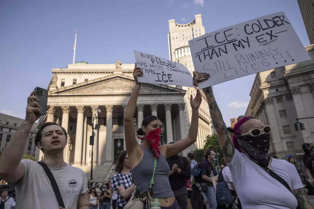 Demonstrators hold signs and chant during a protest against deportation by Immigration and Customs Enforcement in New York, Wednesday, June 11, 2025. (AP Photo/Yuki Iwamura)