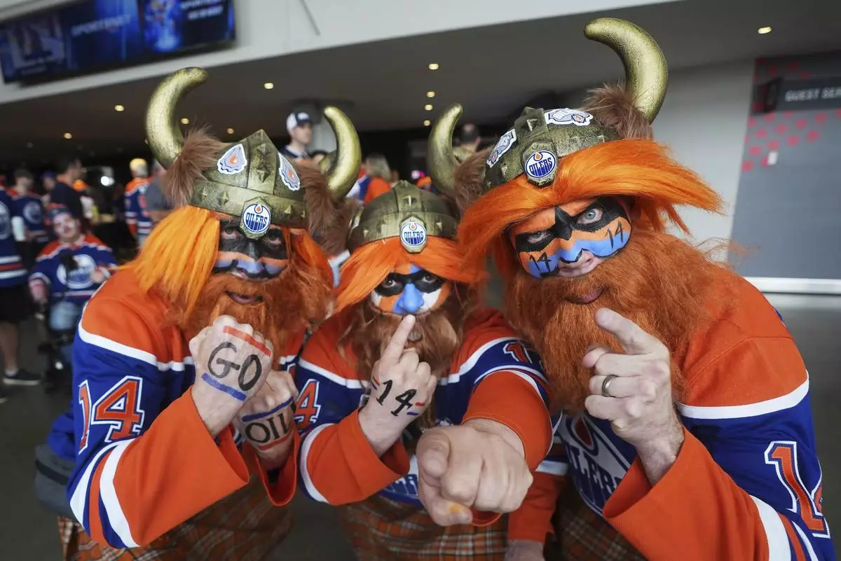 Fans show their support for the Edmonton Oilers before they take on the Florida Panthers in Game 1 of the NHL hockey Stanley Cup final series in Edmonton, Alberta, Wednesday, June 4, 2025. (Darryl Dyck/The Canadian Press via AP)