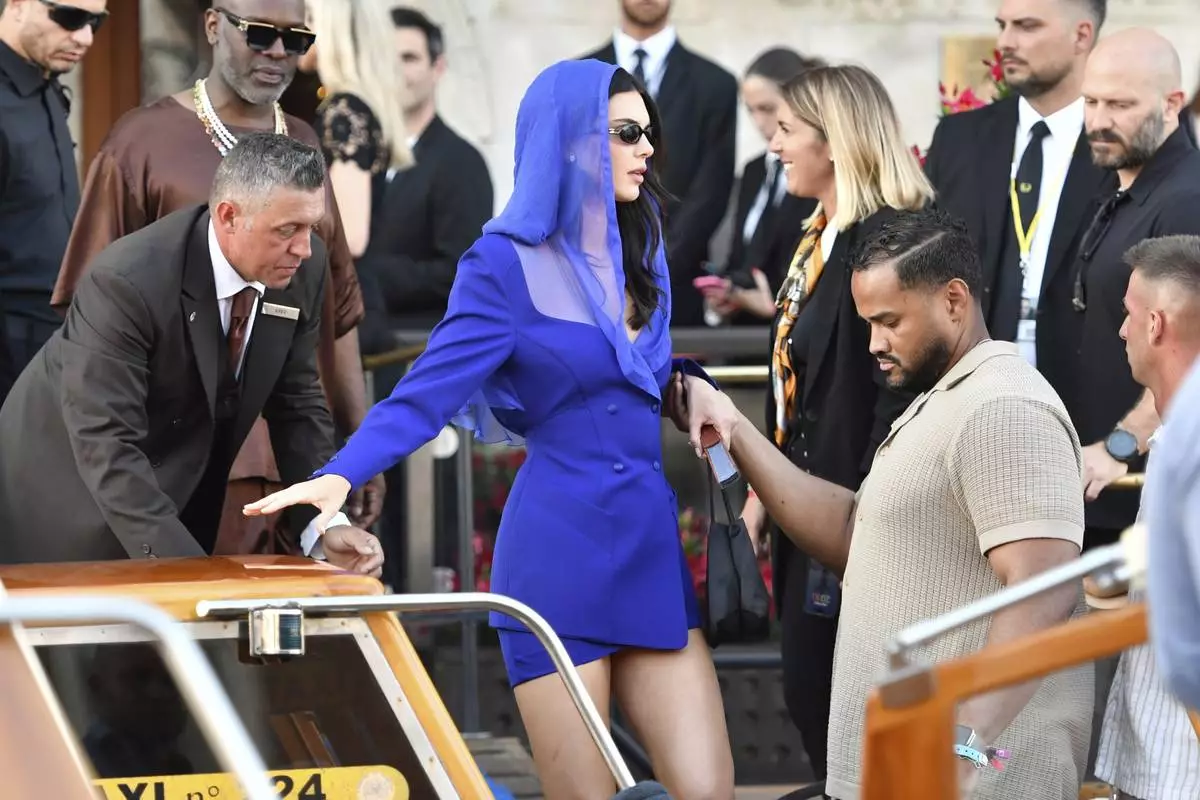 CORRECTS FIRST NAME TO KENDALL, NOT KYLIE - Kendall Jenner, center, leaves a hotel during celebrations for Jeff Bezos and Lauren Sanchez Bezos' wedding, in Venice, Saturday, June 28, 2025. (AP Photo/Luigi Costantini)