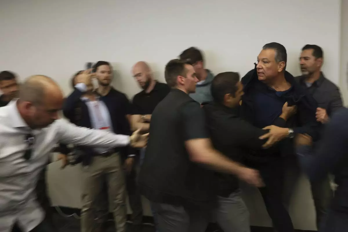 U.S. Sen. Alex Padilla is pushed out of the room as Homeland Security Secretary Kristi Noem holds a news conference regarding the recent protests in Los Angeles on Thursday, June 12, 2025. (AP Photo/Etienne Laurent)