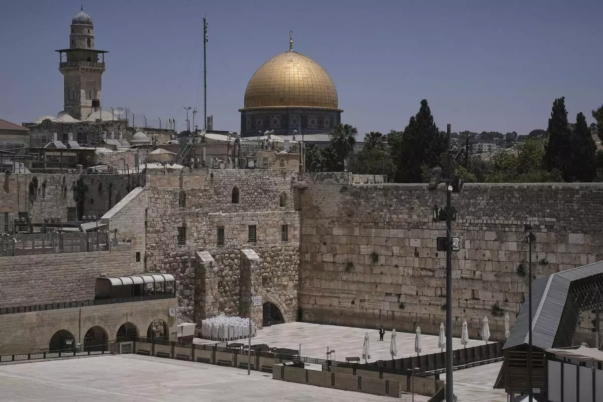 The Western Wall, the holiest site where Jews can pray, stands nearly empty as Israel's Home Front Command banned public gatherings following an Israeli military strike on Iran, in Jerusalem's Old City, Friday, June 13, 2025. (AP Photo/Mahmoud Illean)