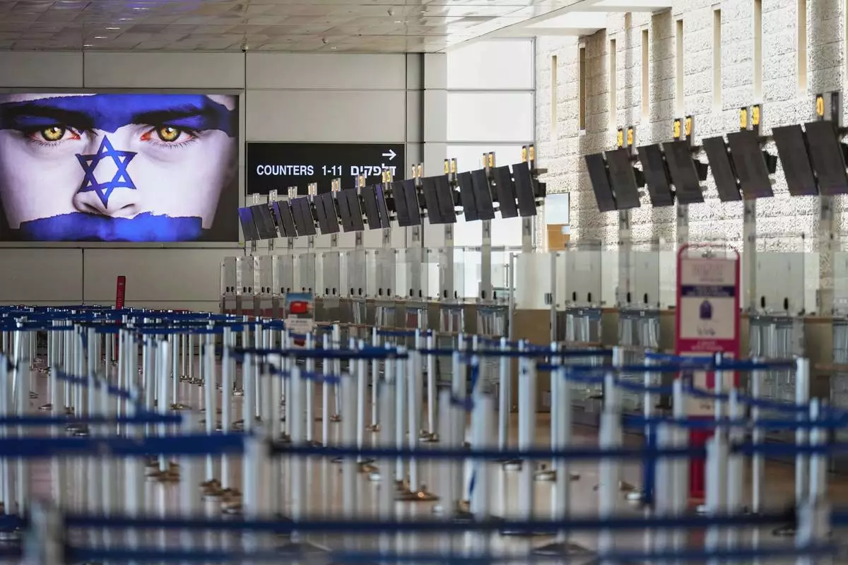 Israel's Ben Gurion Airport is empty of passengers following an Israeli military strike on Iran, in Lod, near Tel Aviv, Israel, Friday, June 13, 2025. (AP Photo/Ariel Schalit)