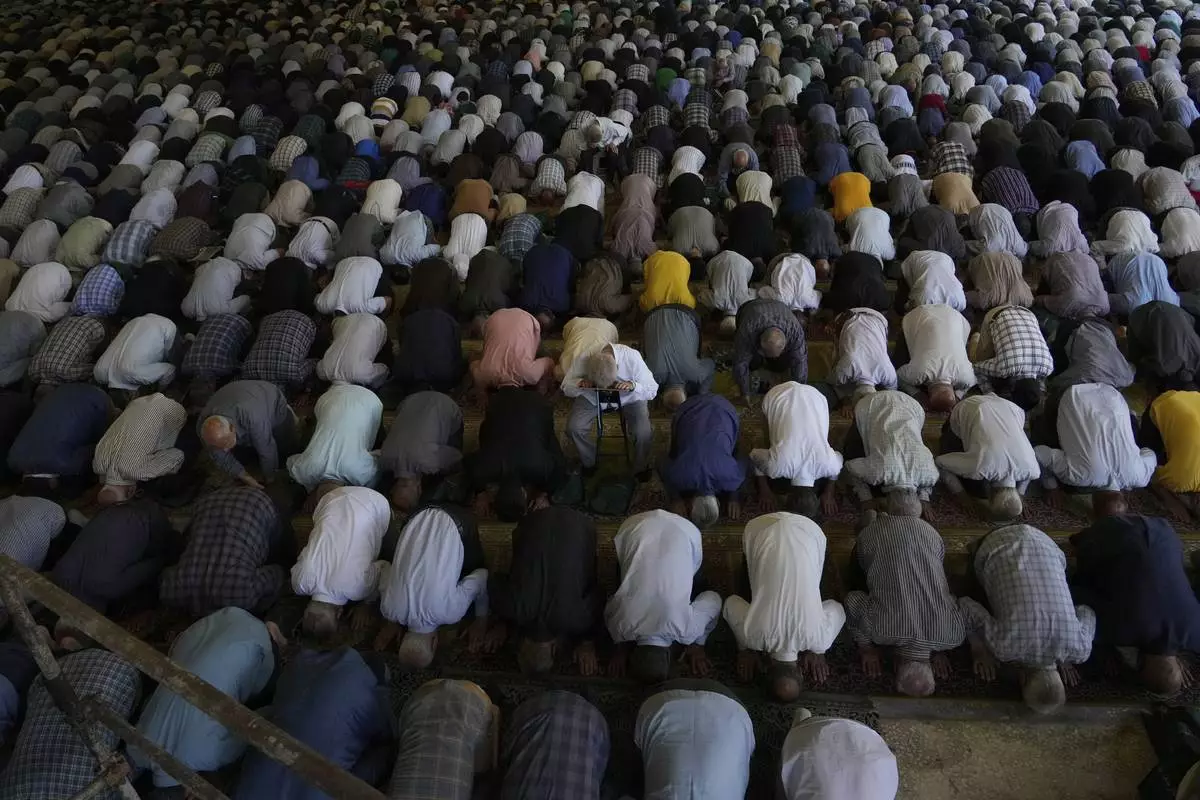 Iranian worshippers perform Friday prayers at Tehran University campus in Tehran, Iran, Friday, June 13, 2025. (AP Photo/Vahid Salemi)