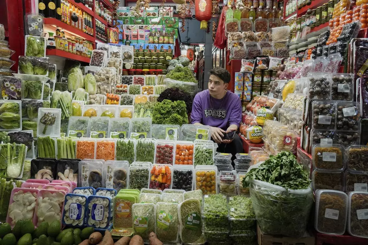 A shopkeeper waits for customers at Tajrish traditional bazaar in northern Tehran, Iran, Friday, June 13, 2025. (AP Photo/Vahid Salemi)