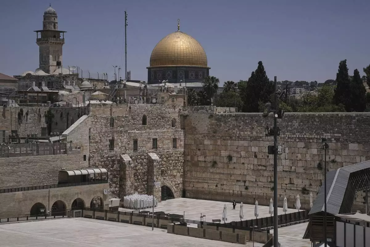 The Western Wall, the holiest site where Jews can pray, stands nearly empty as Israel's Home Front Command banned public gatherings following an Israeli military strike on Iran, in Jerusalem's Old City, Friday, June 13, 2025. (AP Photo/Mahmoud Illean)