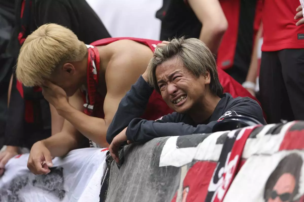 Urawa Red Diamonds fans react after losing against Inter Milan during the Club World Cup Group E soccer match between Inter Milan and Urawa Red Diamonds in Seattle, Saturday, June 21, 2025. (AP Photo/Ryan Sun)