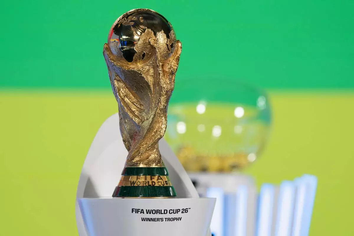 FILE - The World Cup trophy is displayed before the UEFA Preliminary Draw for the 2026 FIFA World Cup soccer tournement at FIFA headquarters in Zurich, Switzerland, Friday, Dec. 13, 2024. (Til Buergy/Keystone via AP, File)