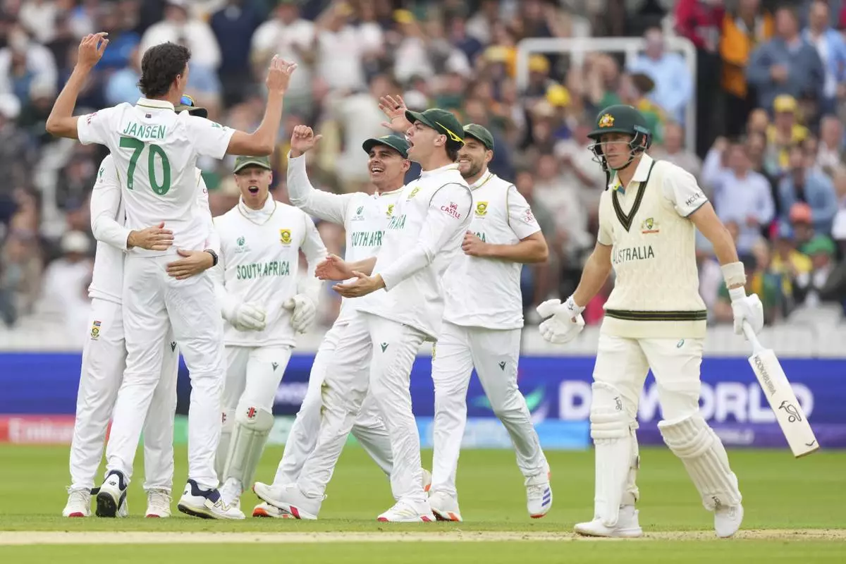 South Africa's Marco Jansen, left, celebrates with teammates after the dismissal of Australia's Marnus Labuschagne, right, during the World Test Championship final between South Africa and Australia at Lord's cricket ground in London, Wednesday, June 11, 2025. (AP Photo/Kirsty Wigglesworth)