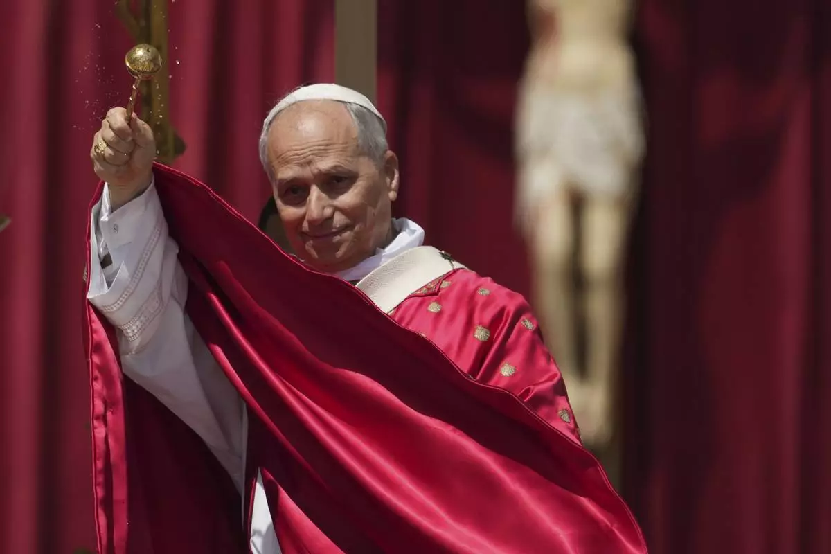 FILE - Pope Leo XIV spreads holy water as he celebrates a Mass for the Jubilee of New Religious Associations on Pentecost Day in St. Peter's Square at the Vatican, Sunday, June 8, 2025. (AP Photo/Andrew Medichini, File)