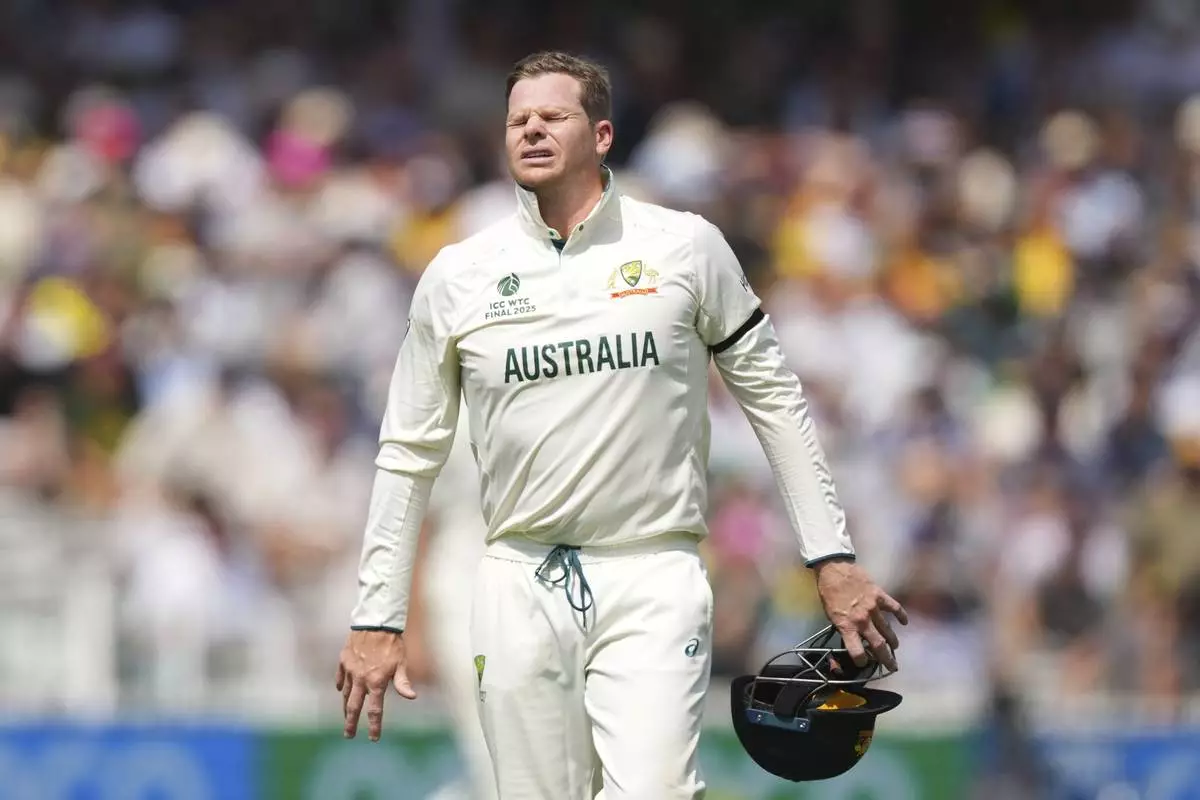 Australia's Steve Smith reacts after getting hurt while fielding on day three of the World Test Championship final between South Africa and Australia at Lord's cricket ground in London, Friday, June 13, 2025. (AP Photo/Kirsty Wigglesworth)