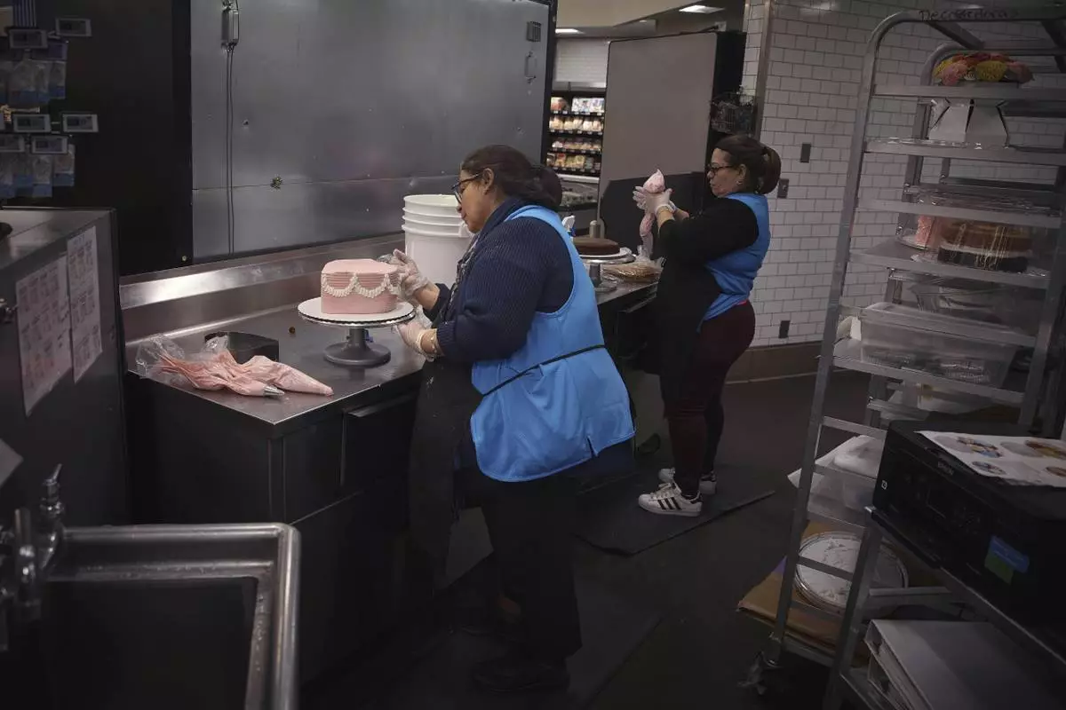 Employees make cakes inside Walmart Supercenter on Wednesday, May 28, 2025, in North Bergen, N.J. (AP Photo/Andres Kudacki)