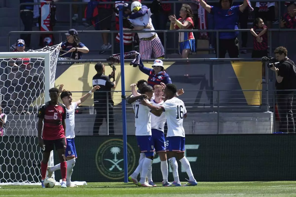 United States forward Malik Tillman, center left, celebrates with teammates after scoring against Trinidad and Tobago during the first half of a CONCACAF Gold Cup soccer match in San Jose, Calif., Sunday, June 15, 2025. (AP Photo/Jeff Chiu)