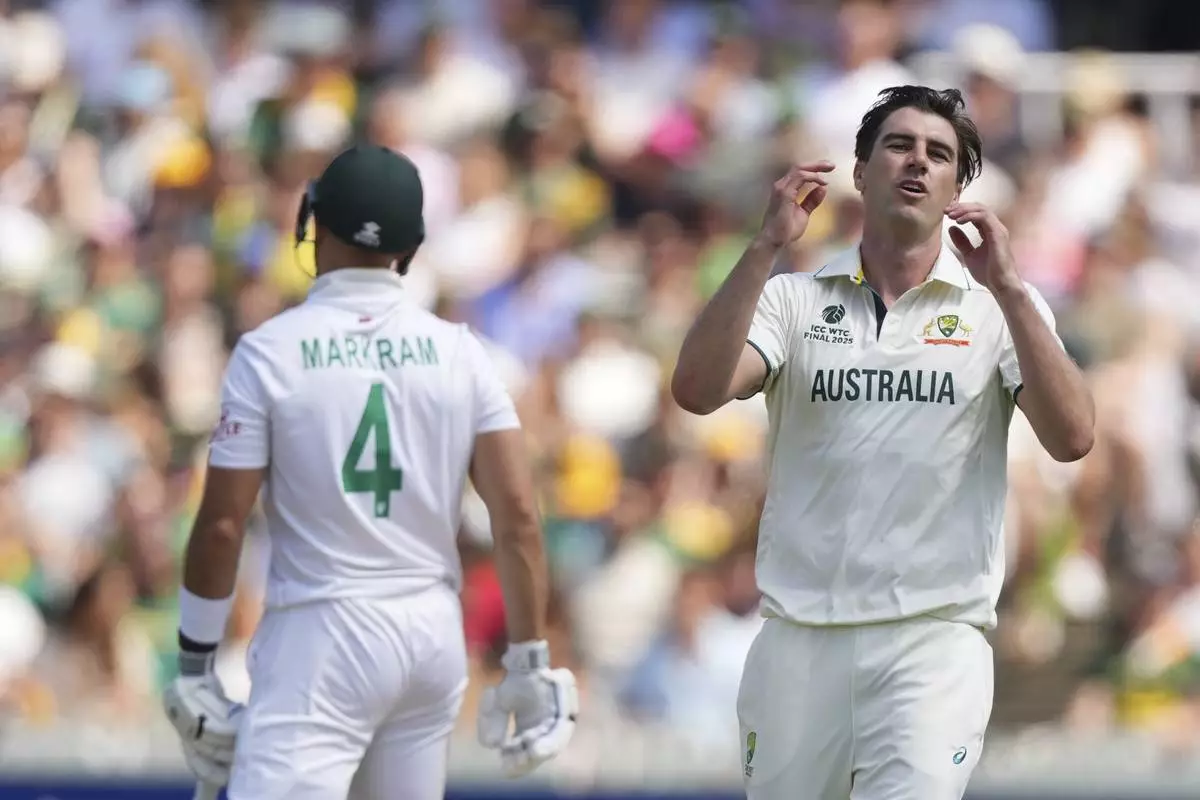 Australia's captain Pat Cummins, right, reacts after bowling a delivery on day four of the World Test Championship final between South Africa and Australia at Lord's cricket ground in London, Saturday, June 14, 2025. (AP Photo/Kirsty Wigglesworth)