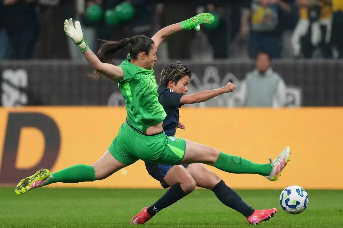 Japan's Mina Tanaka, right, scores her side's opening goal that was later disallowed by the referee, during a women's friendly soccer match against Brazil at Neo Quimica Arena in Sao Paulo, Friday, May 30, 2025. (AP Photo/Andre Penner)