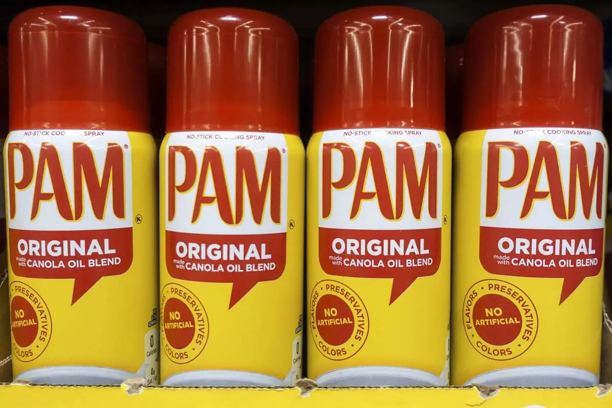 FILE - Cans of PAM cooking spray, a Conagra brand, rest on a supermarket shelf in Cincinnati, June 25, 2019. (AP Photo/John Minchillo, File)