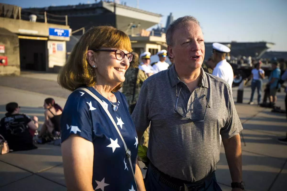 Cindy and Andrew Forrest came to send off their son, surface warfare officer Andrew Forrest, 28, on the USS Gerald R. Ford as the aircraft carrier prepares to leave for deployment from Naval Station Norfolk, Tuesday, June 24, 2025, in Norfolk, Va. (AP Photo/John Clark)