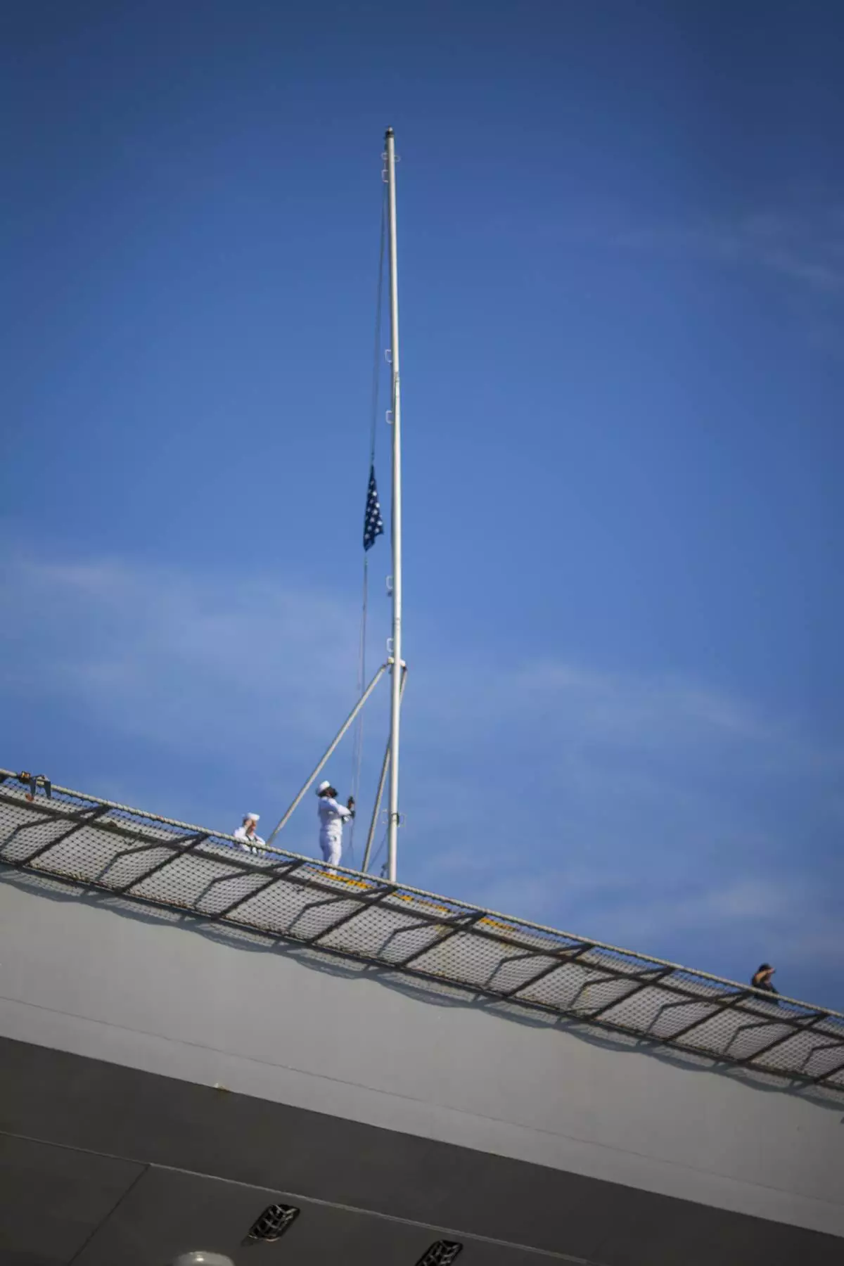 Sailors raise the Colors as the USS Gerald R. Ford aircraft carrier prepares to go underway from Naval Station Norfolk, Tuesday, June 24, 2025, in Norfolk, Va. (AP Photo/John Clark)