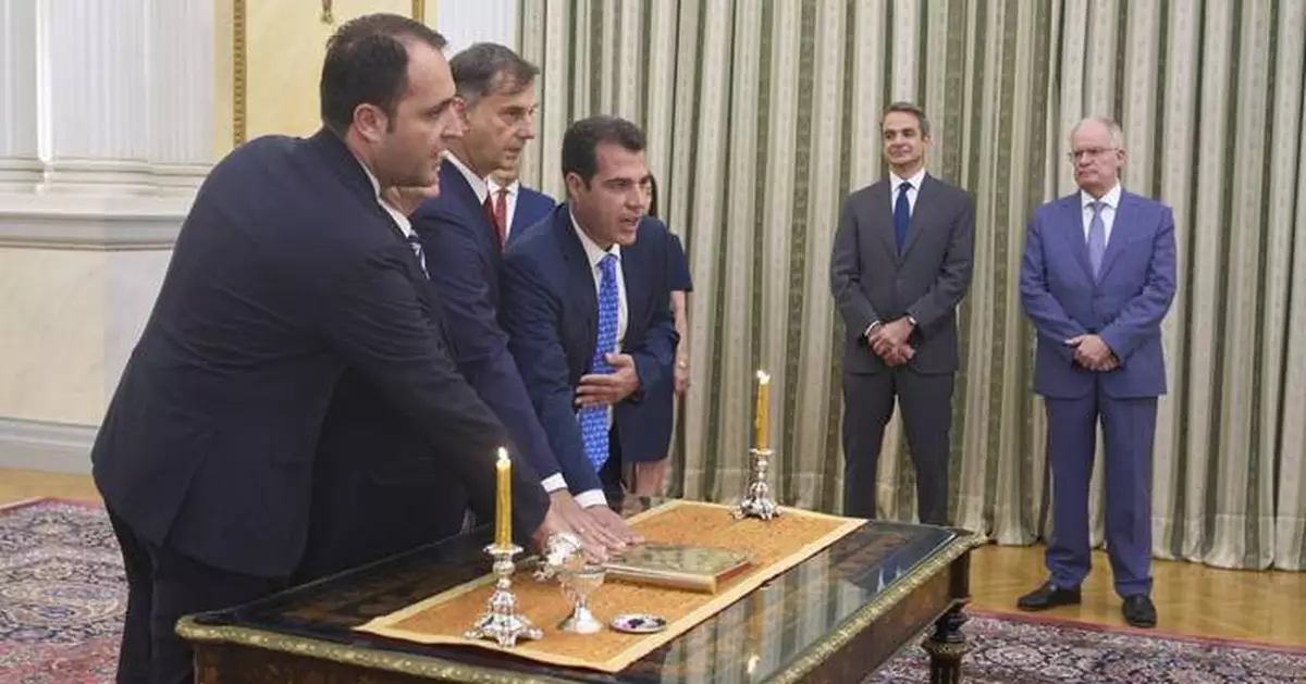 A hard-right lawmaker is sworn in as Greece's migration minister