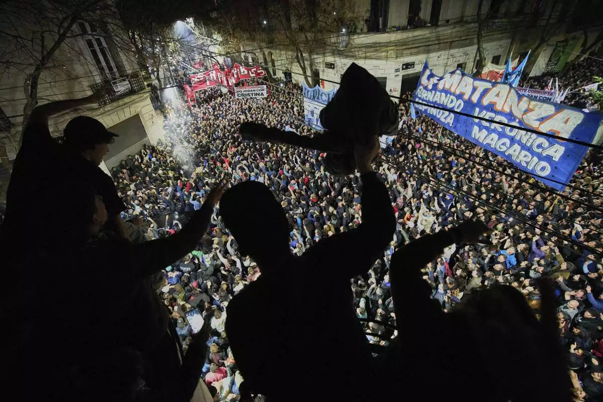 Supporters of former President Cristina Fernandez gather outside her residence after Argentina's Supreme Court upheld a six-year prison sentence over her corruption conviction, in Buenos Aires, June 10, 2025. (AP Photo/Rodrigo Abd)