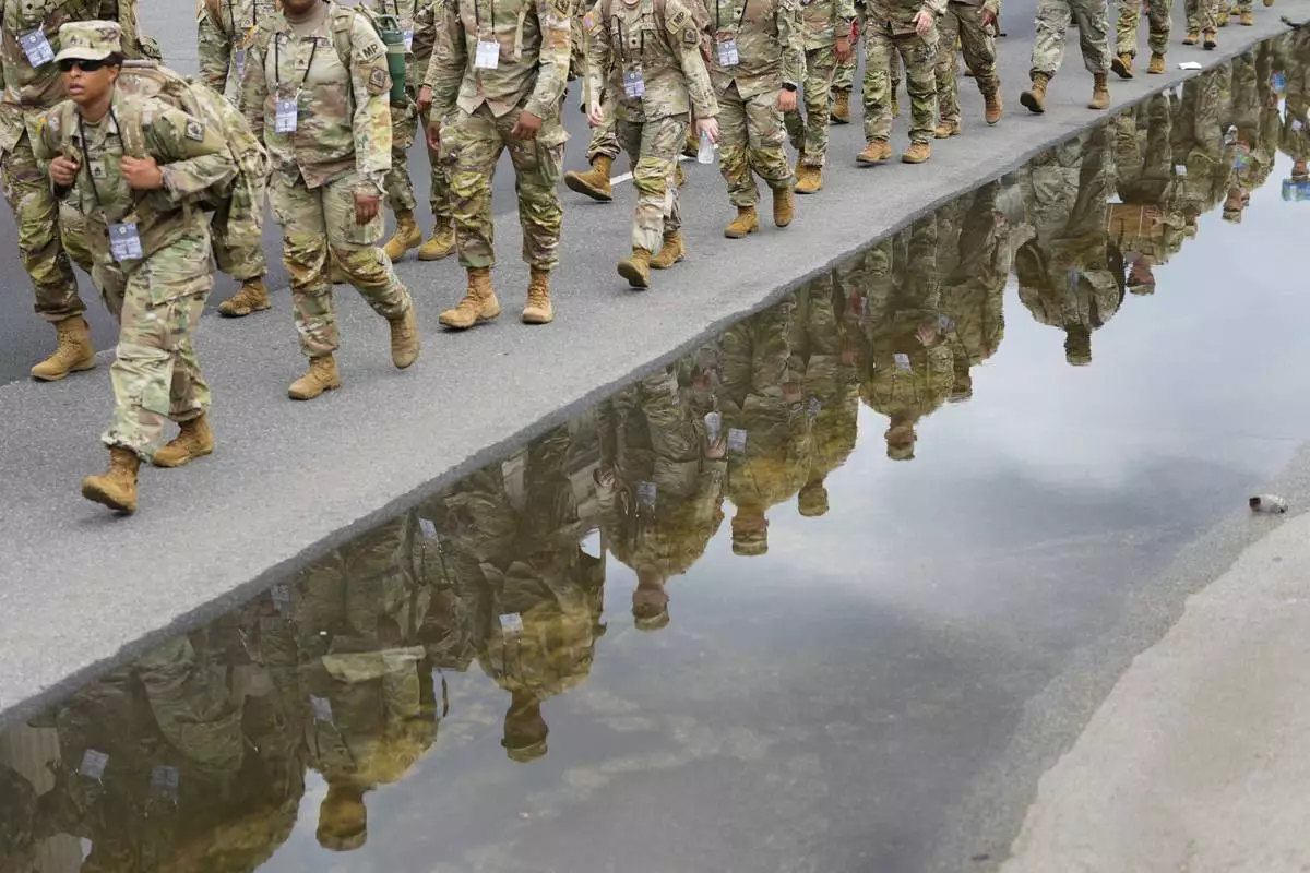 U.S. Army soldiers walking along Constitution Ave., on the National Mall ahead of a parade commemorating the Army's 250th anniversary and coinciding with President Donald Trump's 79th birthday, Saturday, June 14, 2025, in Washington. (AP Photo/Pablo Martinez Monsivais)