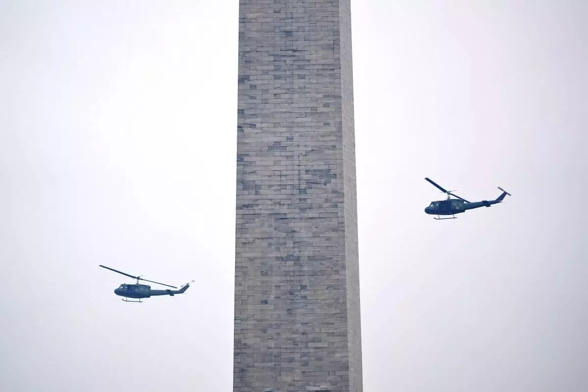U.S. Army UH-60M Black Hawk helicopters perform a flyover during an event to honor the Army's 250th anniversary, coinciding with President Donald Trump's 79th birthday, Saturday, June 14, 2025, in Washington. (AP Photo/Mark Schiefelbein)