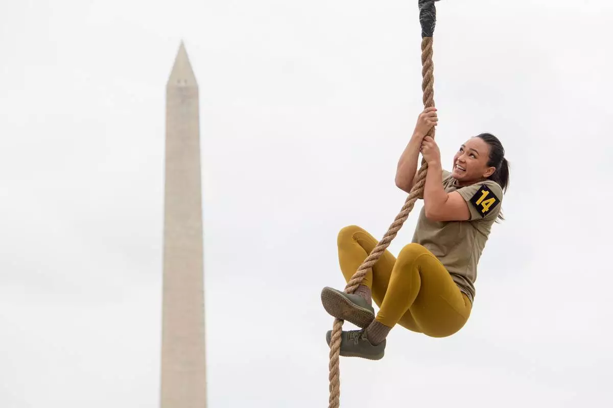 A team member competes in the rope climb portion of the Army fitness competition during the festival event to honor the Army's 250th anniversary, coinciding with President Donald Trump's 79th birthday, Saturday, June 14, 2025, on the National Mall in Washington. (AP Photo/Rod Lamkey, Jr.)