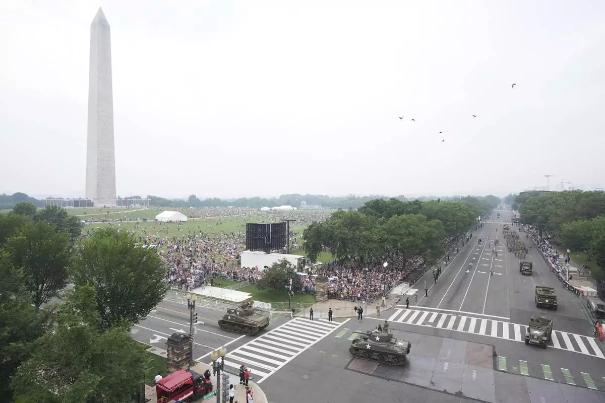 A military parade commemorating the Army's 250th anniversary and coinciding with President Donald Trump's 79th birthday, Saturday, June 14, 2025, in Washington. The Washington Monument stands left. (AP Photo/Jacquelyn Martin)