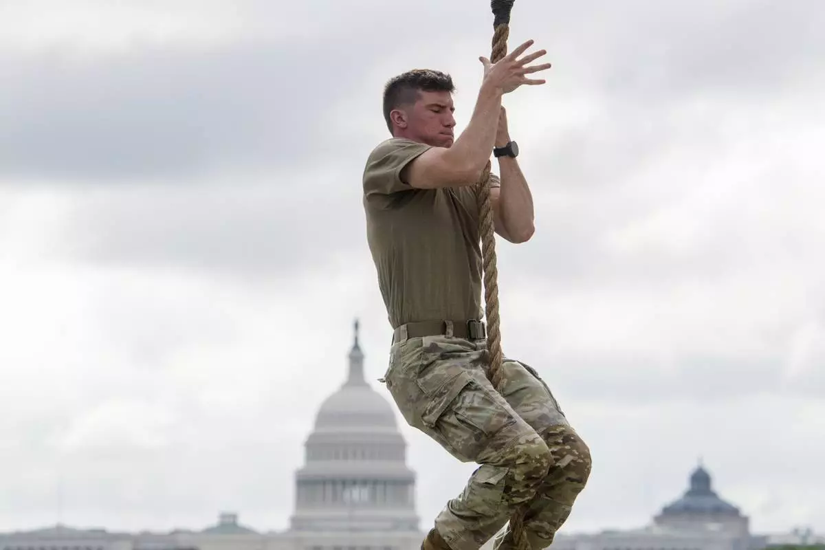 Teams warm up on the rope climb portion of the Army fitness competition, during a festival event to honor the Army's 250th anniversary and coinciding with President Donald Trump's 79th birthday, Saturday, June 14, 2025, in Washington. (AP Photo/Rod Lamkey, Jr.)