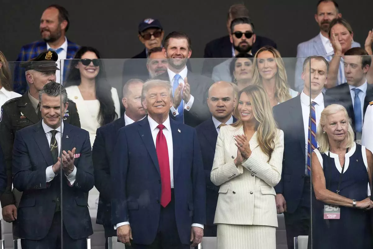 President Donald Trump, first lady Melania Trump, and Defense Secretary Pete Hegseth, left, attend a military parade commemorating the Army's 250th anniversary, coinciding with his 79th birthday, Saturday, June 14, 2025, in Washington. (AP Photo/Julia Demaree Nikhinson)