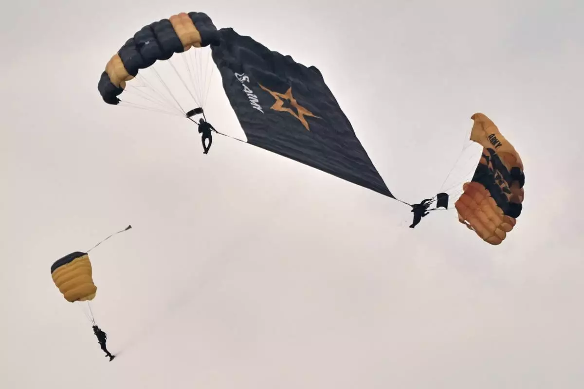 U.S. Army Parachute Team, nicknamed the Golden Knights, participate in the Army's 250th anniversary ceremony, coinciding with President Donald Trump's 79th birthday, Saturday, June 14, 2025, in Washington. (AP Photo/Jacquelyn Martin)