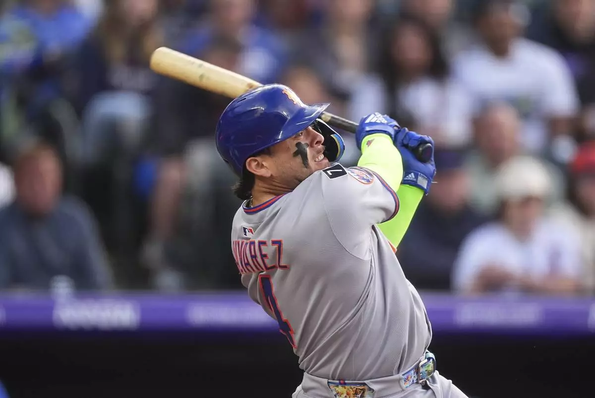 New York Mets' Francisco Alvarez singles in the second inning of a baseball game against the Colorado Rockies Friday, June 6, 2025, in Denver. (AP Photo/David Zalubowski)