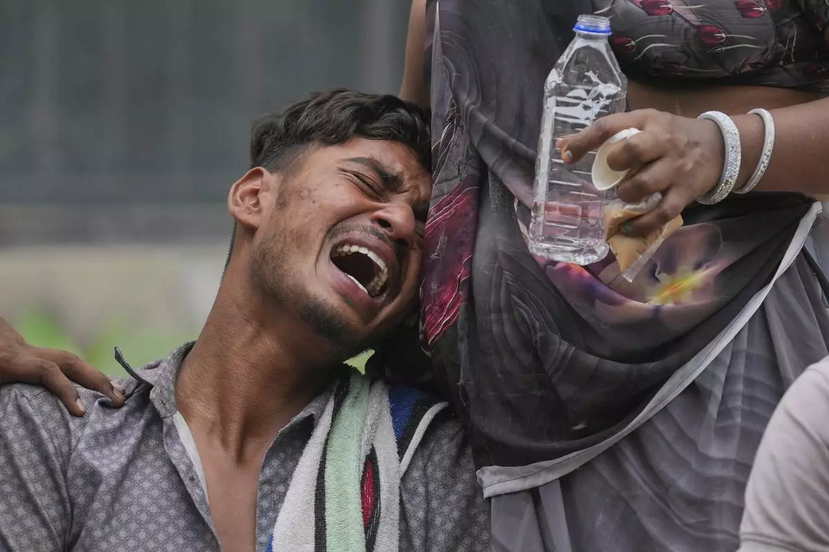 Kalpesh Bhai, whose 14-year-old brother was killed when an Air India plane crashed into a neighborhood, wails outside the autopsy room at a hospital in Ahmedabad, India, Friday, June 13, 2025. (AP Photo/Rafiq Maqbool)