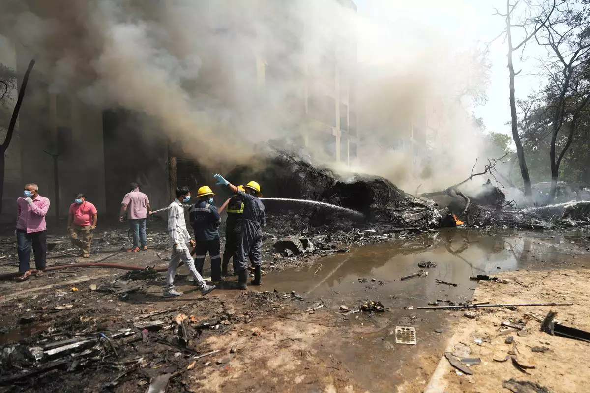 Firefighters work at the site of an airplane that crashed in India's northwestern city of Ahmedabad in Gujarat state, Thursday, June 12, 2025. (AP Photo/Ajit Solanki)