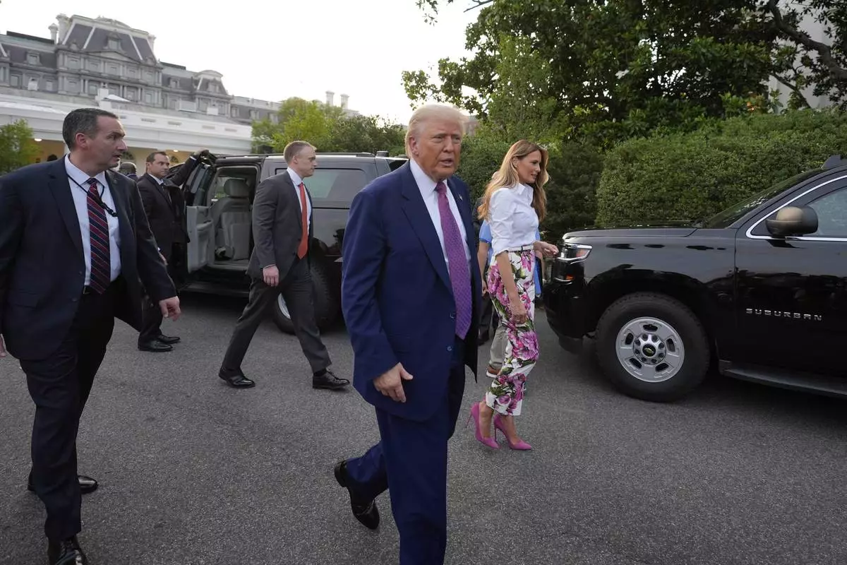President Donald Trump and first lady Melania Trump walk after greeting guests during the congressional picnic on the South Lawn of the White House, Thursday, June 12, 2025, in Washington. (AP Photo/Alex Brandon)