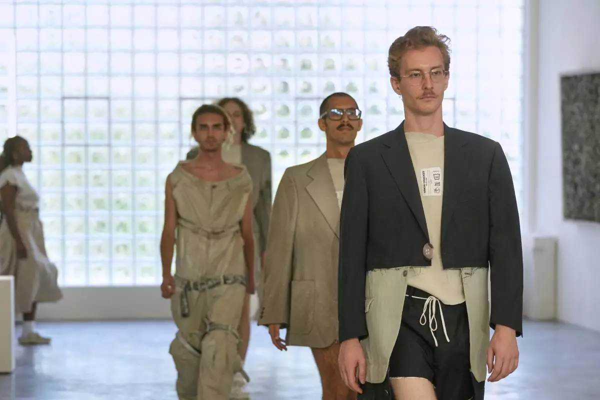 Models wear creations as part of the men's Simon Cracker Spring-Summer 2026 collection, that was presented in Milan, Italy, Sunday, June 22, 2025. (AP Photo/Luca Bruno)