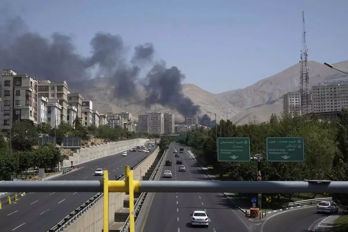 Smoke rises from an oil storage facility after it appeared to have been struck by an Israeli strike on Saturday, in Tehran, Iran, Monday, June 16, 2025. (AP Photo/Vahid Salemi)