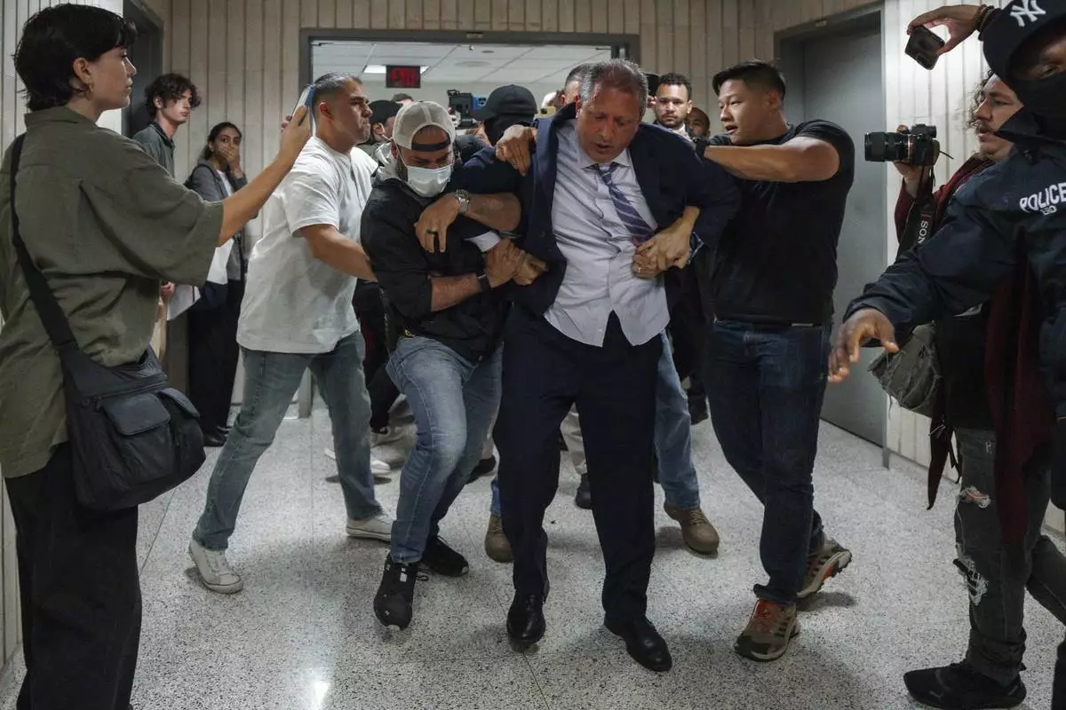New York City Comptroller Brad Lander is placed under arrest by Immigration and Customs Enforcement (ICE) and FBI agents outside federal immigration court on Tuesday, June 17, 2025, in New York. (AP Photo/Olga Fedorova)