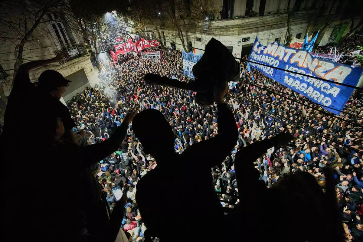 Supporters of former President Cristina Fernandez chant slogans in front of her home after Argentina's Supreme Court upheld her corruption conviction, in Buenos Aires, Argentina, Tuesday, June 10, 2025. (AP Photo/Rodrigo Abd)